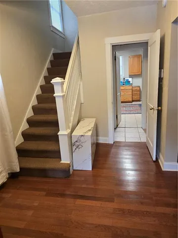 a view of entryway and hall with wooden floor