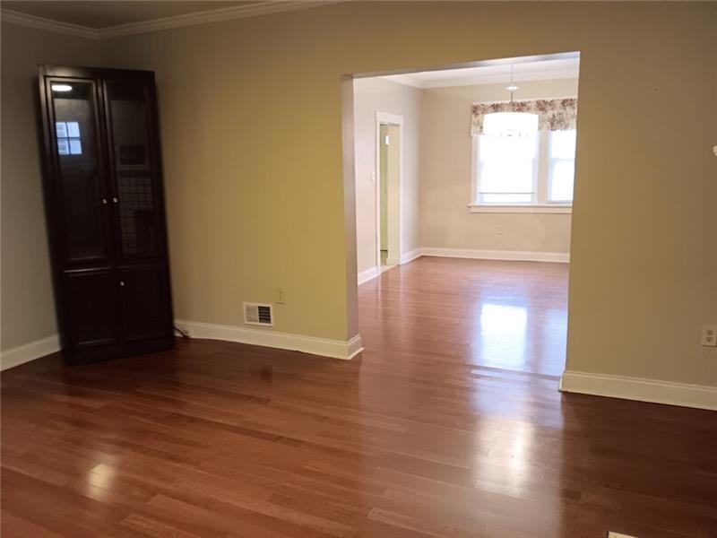 6501 Deary Street Pittsburgh, PA 15206 - Photo 8 of 47 an empty room with wooden floor and windows