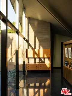 a living room with fireplace furniture and a large window