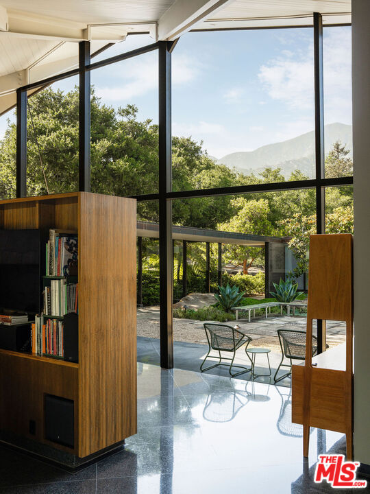 650 San Ysidro Road Santa Barbara, CA 93108 - Photo 16 of 55 a living room with a floor to ceiling window and wooden floor