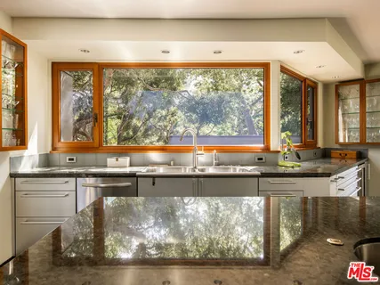a view of hallway with a large window and wooden floor