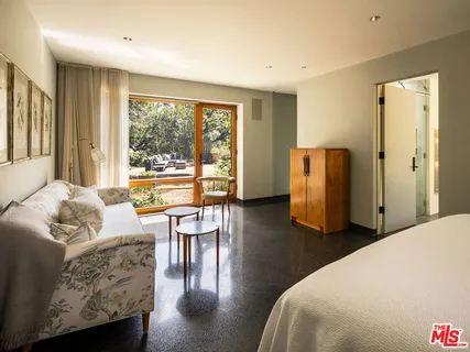 a view of living room with furniture and large window
