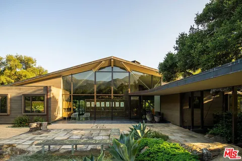 a view of a chair and tables in patio