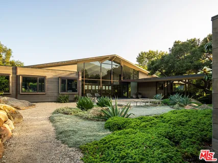 a front view of house with yard outdoor seating and barbeque oven