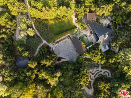 a view of a house with a yard and garden