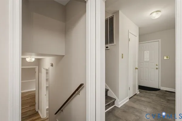 a view of a hallway with closet and stairs