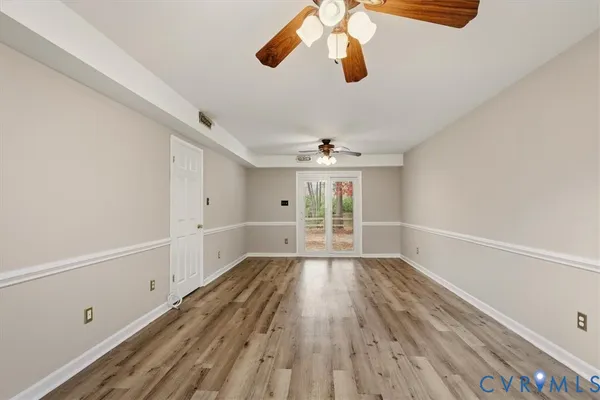 wooden floor in an empty room with a window