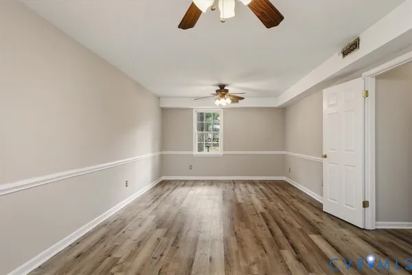 wooden floor in an empty room with a window