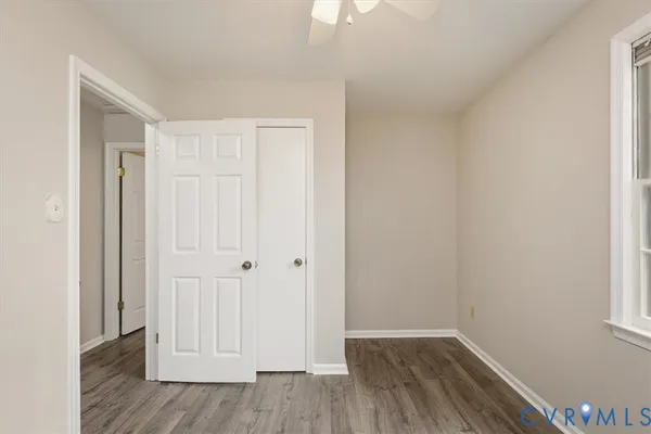 a view of an empty room with wooden floor