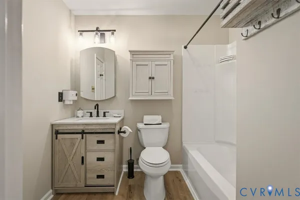 a bathroom with a toilet a sink and bathtub