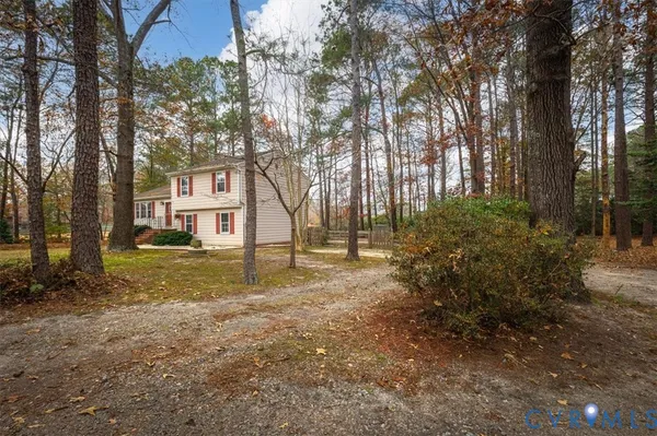 a view of a house with a yard and tree s