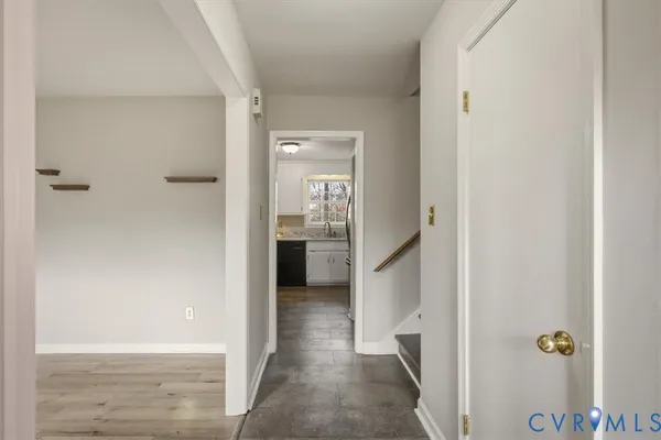 a view of a hallway with wooden shelves