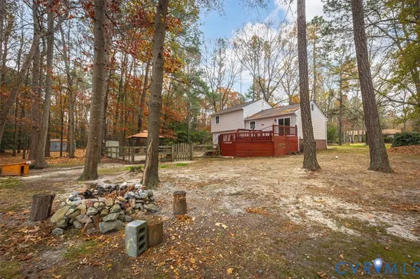 a front view of a house with a yard covered with snow and trees
