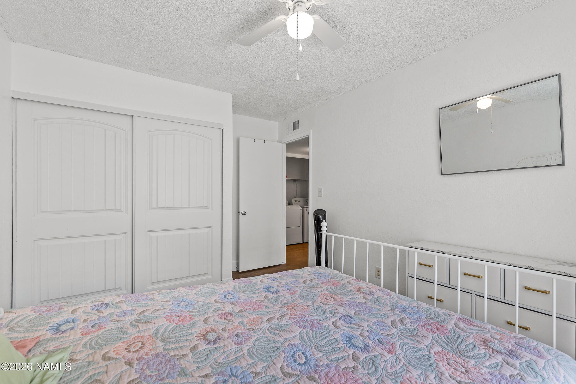 4367 East Hollygreen Road Flagstaff, AZ 86004 - Photo 14 of 21 a bedroom with a large bed and a chandelier