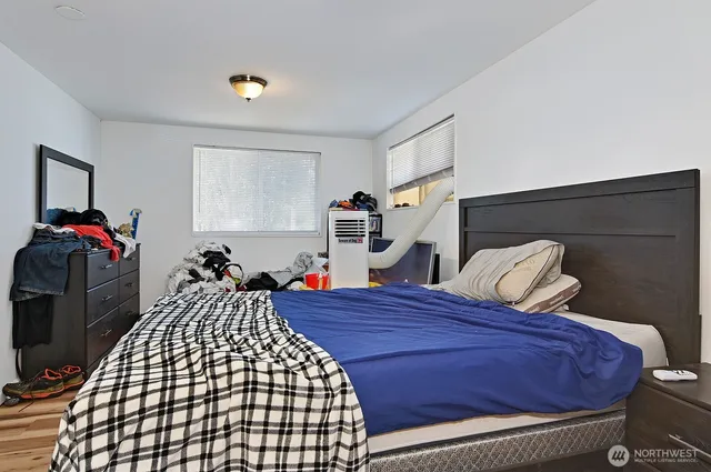 a bed sitting in a bedroom next to a window