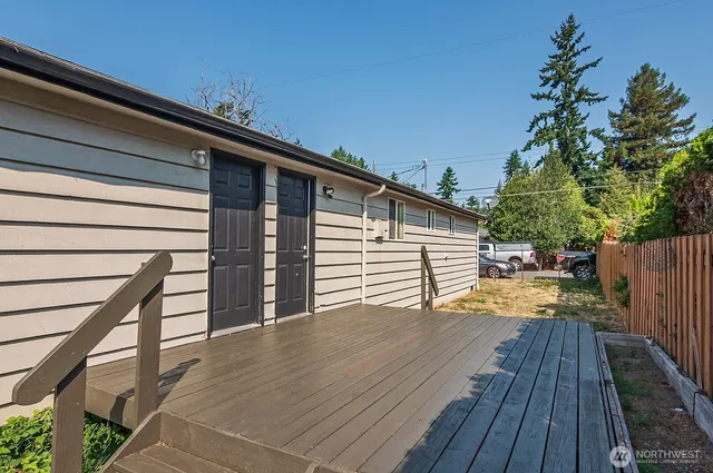 a view of a deck with wooden floor and fence and a wooden floor
