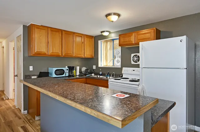 a kitchen with stainless steel appliances granite countertop a sink refrigerator and stove