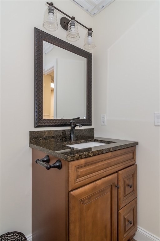 7 Red Gap Road Wilbraham, MA 01095 - Photo 25 of 31 a bathroom with a granite countertop sink a mirror and cabinets