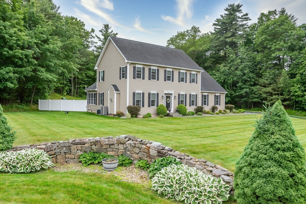 7 Red Gap Road Wilbraham, MA 01095 - Photo 26 of 31 a front view of a house with a yard table and chairs