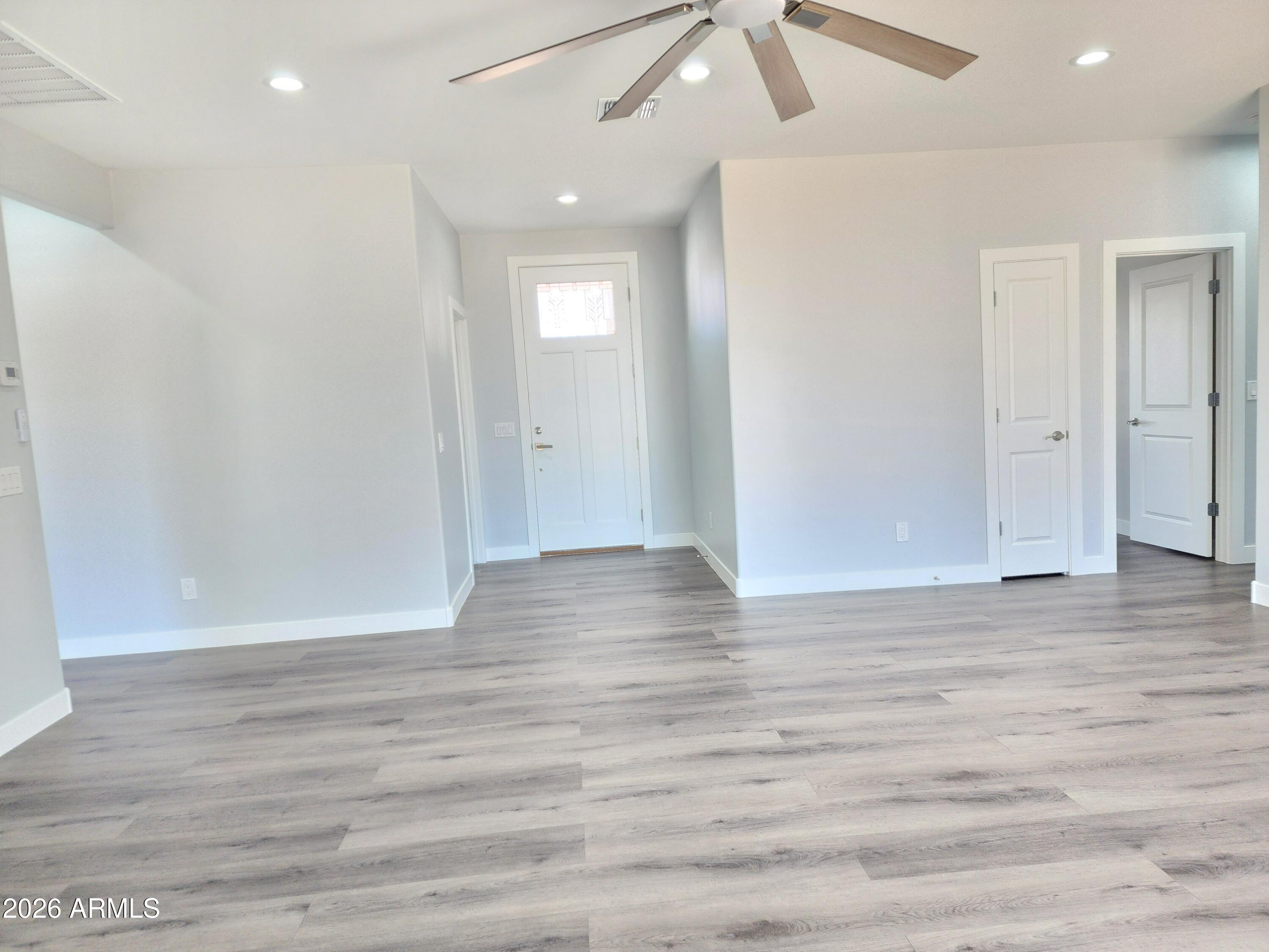 13564 South Durango Road Arizona City, AZ 85123 - Photo 20 of 30 a view of an empty room with wooden floor and fan