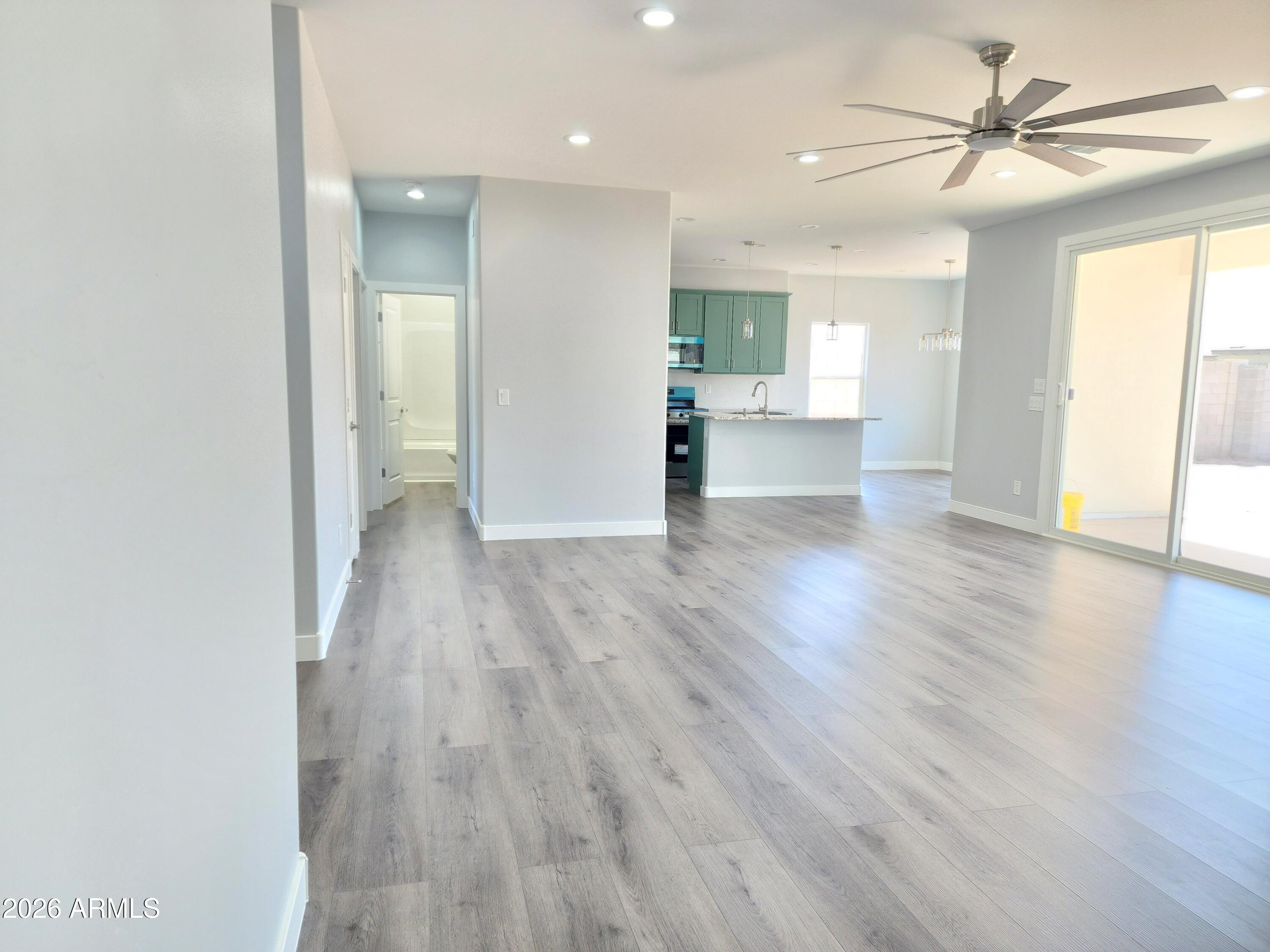 13564 South Durango Road Arizona City, AZ 85123 - Photo 21 of 30 a view of empty room with wooden floor and fan