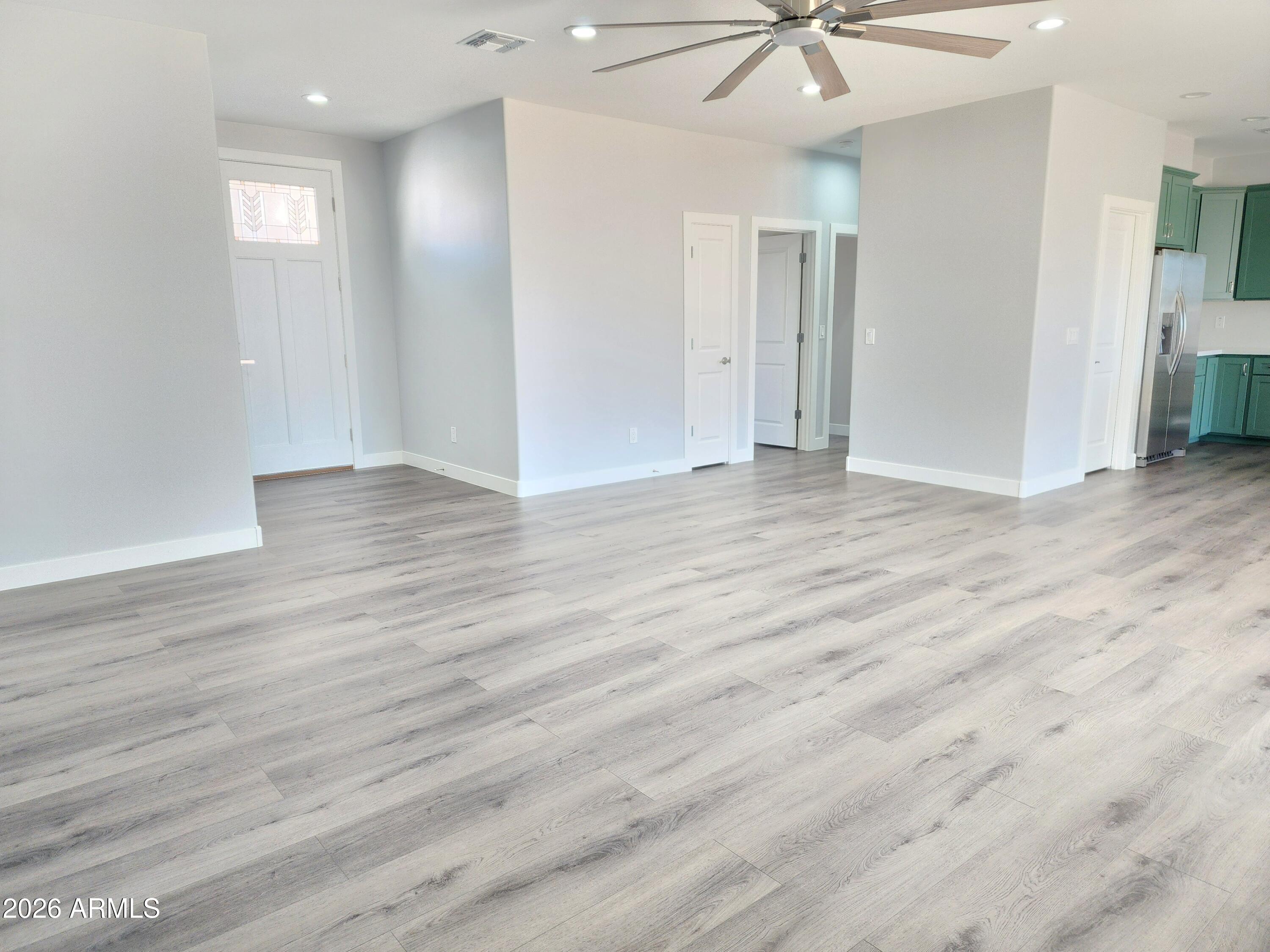 13564 South Durango Road Arizona City, AZ 85123 - Photo 23 of 30 an empty room with wooden floor and a ceiling fan