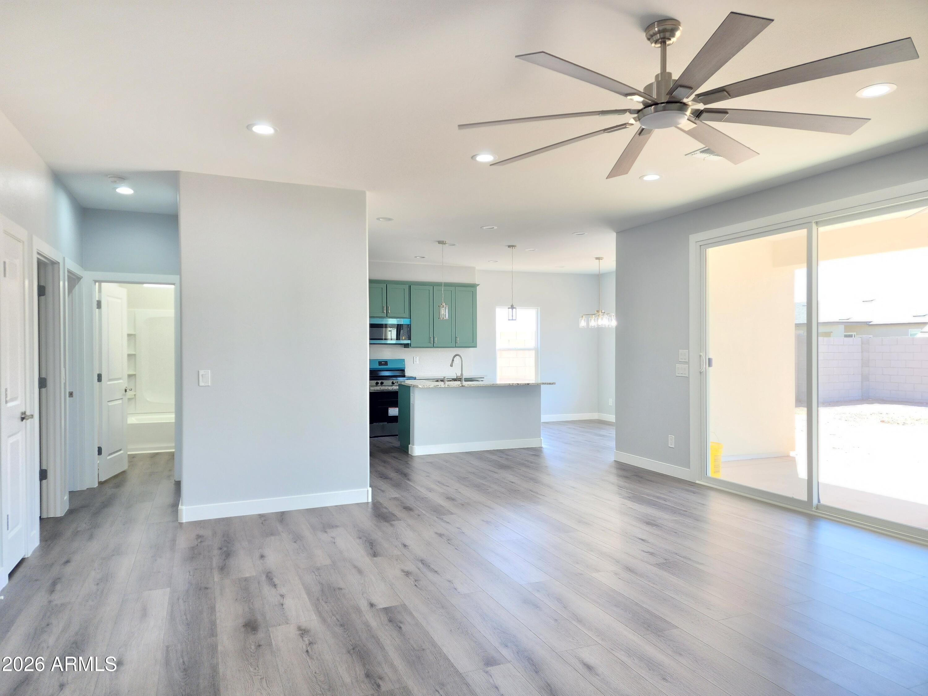 13564 South Durango Road Arizona City, AZ 85123 - Photo 24 of 30 a view of an empty room with wooden floor and a window