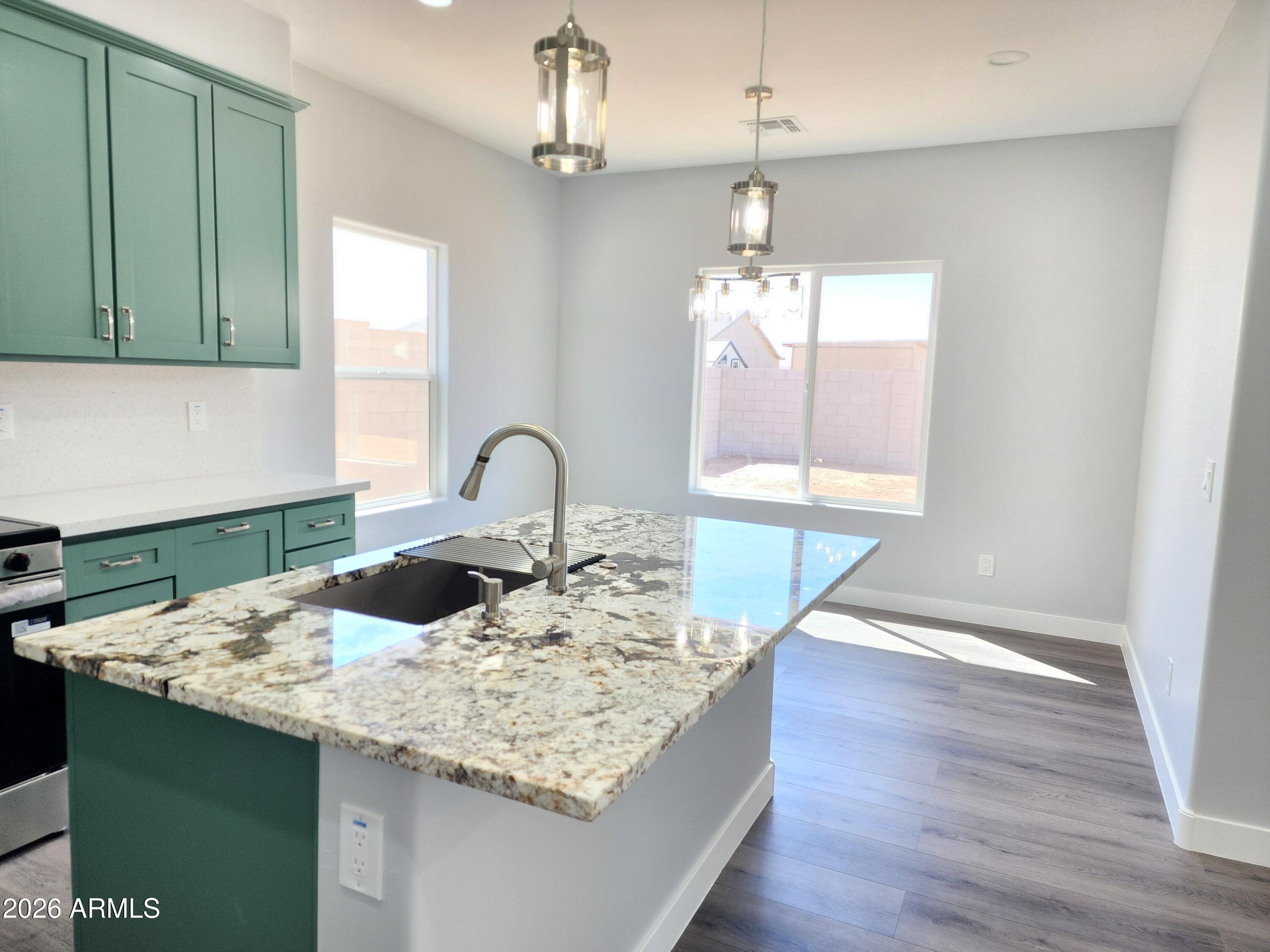 13564 South Durango Road Arizona City, AZ 85123 - Photo 26 of 30 a view of a kitchen area with furniture and wooden floor