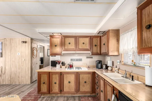 a kitchen with cabinets appliances and a window