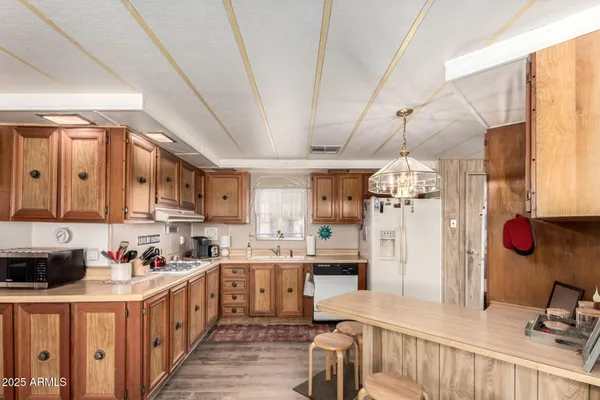 a kitchen with stainless steel appliances kitchen island granite countertop a sink and cabinets