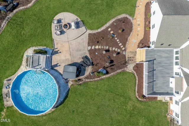 a view of a house with swimming pool and yard