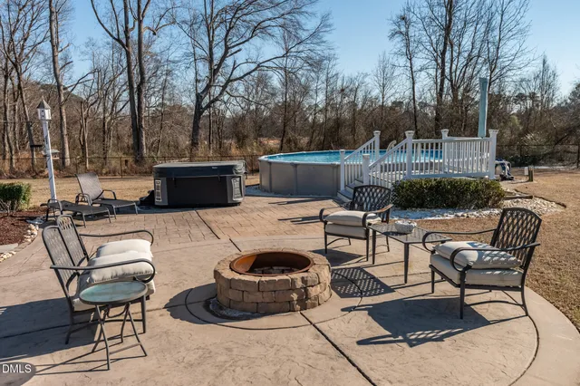 an aerial view of a house with swimming pool garden and outdoor seating