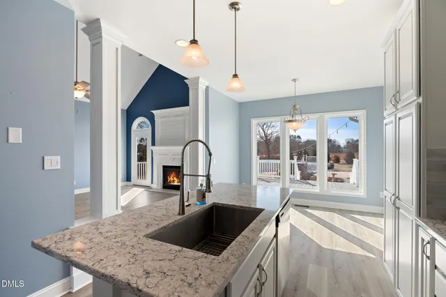a kitchen with granite countertop a sink and steel appliances