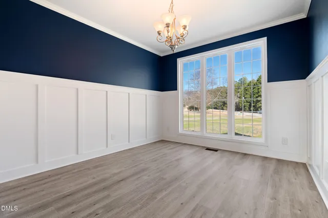 a kitchen with granite countertop a sink and a refrigerator