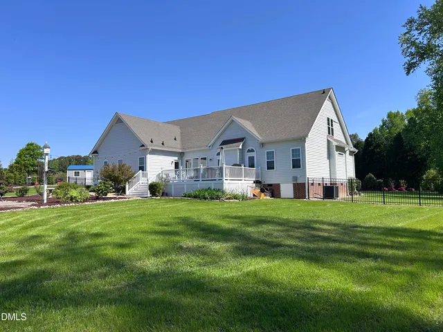 a view of a house with wooden fence