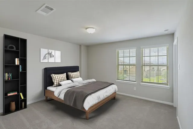 a bed sitting in a bedroom next to a window