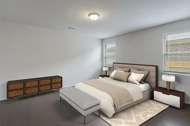 a bedroom with a bed and a night stand