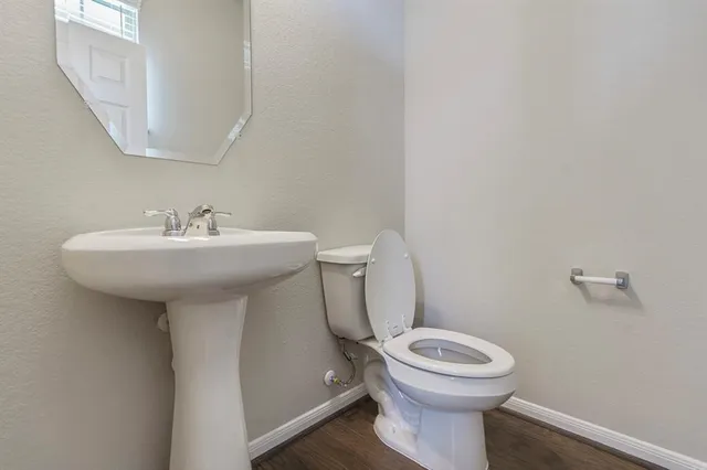 a bathroom with a sink mirror toilet and a mirror