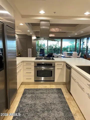a kitchen with a stove a sink and a refrigerator