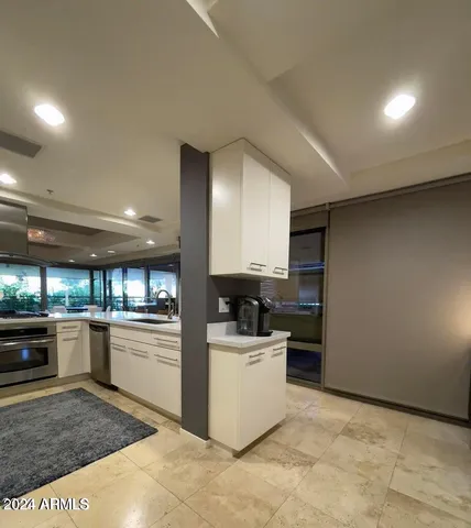 a kitchen with stainless steel appliances kitchen island granite countertop a sink and stove top oven