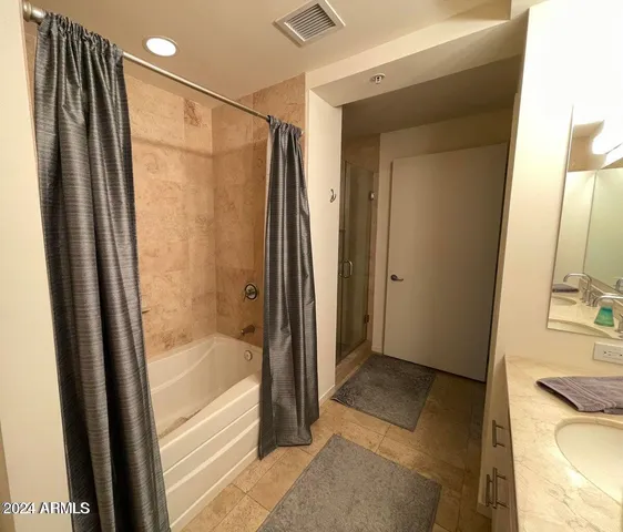 a bathroom with a bathtub and a shower