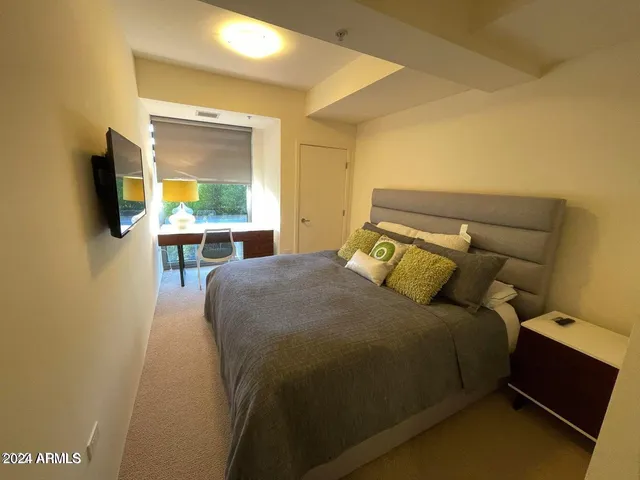 a bed sitting in a bedroom next to a window