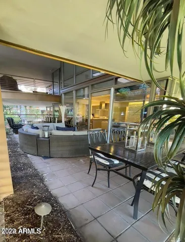 a view of a chairs and table in a patio
