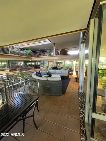 a view of a patio with dining table and chairs