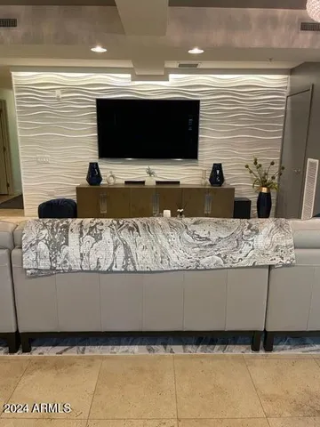 a living room with couches and a flat screen tv