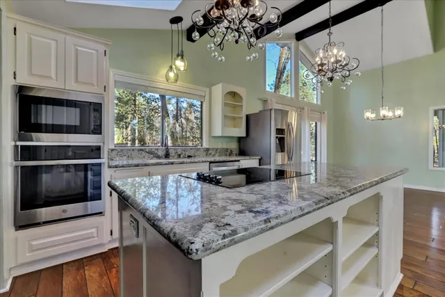 a view of a livingroom with wooden floor and stairs