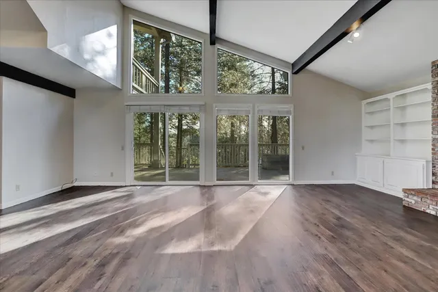 a view of an empty room with windows