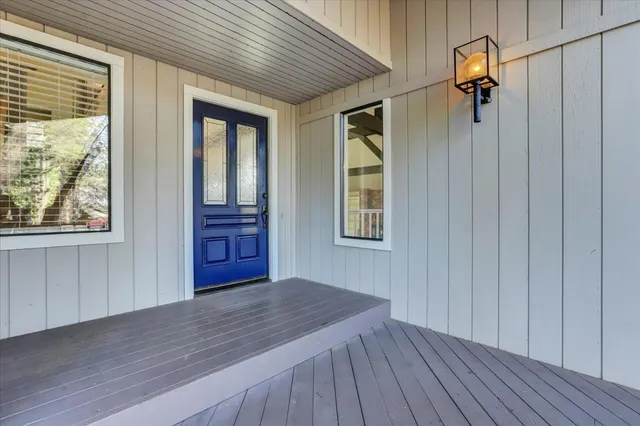 a view of a hallway with wooden floor and entryway