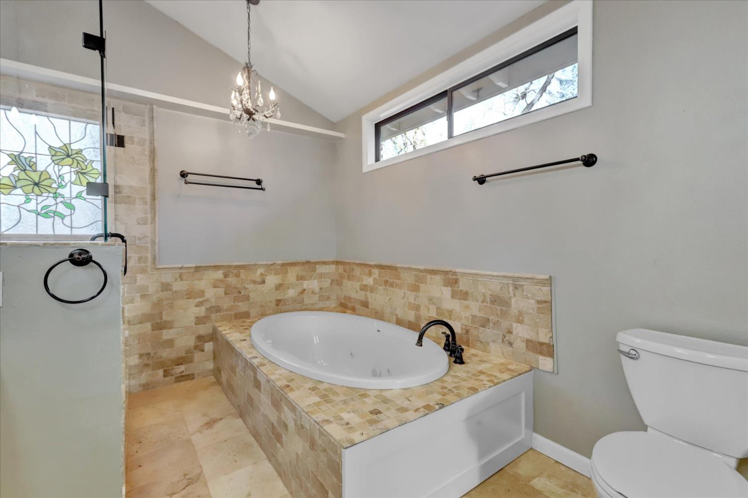 15017 Pammy Way Grass Valley, CA 95949 - Photo 43 of 99 a bathroom with a granite countertop sink a toilet a mirror and shower