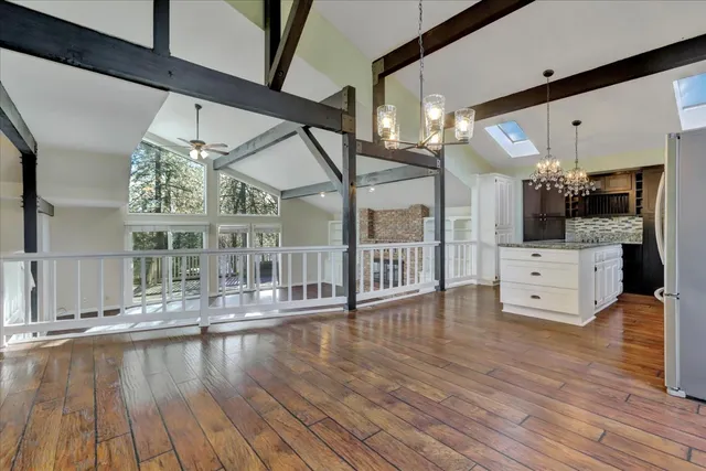 a kitchen with stainless steel appliances kitchen island granite countertop a refrigerator and a stove top oven